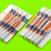 Две банданы VeloFlow с геометрическим принтом, сложенные гармошкой на ярко-салатовом фоне