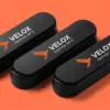 Три парковочные визитки Velox веером — оранжевый логотип сокола на чёрном матовом пластике