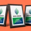 Три плакетки ECO-VISION на коралловом фоне в динамичной композиции три четверти, деревянная основа в объёме
